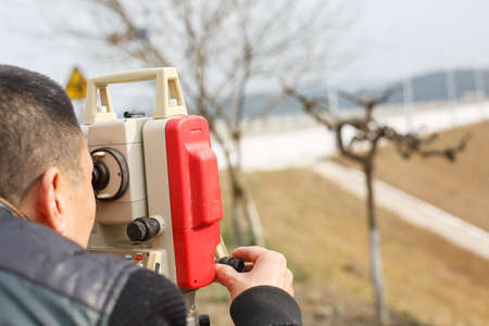 Surveyor engineer  making measure on the field