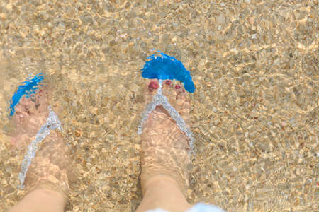 Beach and a pair of blue slippers