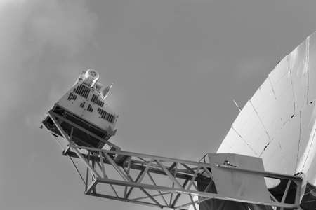 Satellite system is directed in sky (Black and white photo)の写真素材