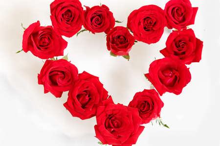 Heart Shaped Red Rose Arrangement on a White Backgroundの写真素材