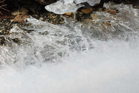 Ice lines the stream flowing