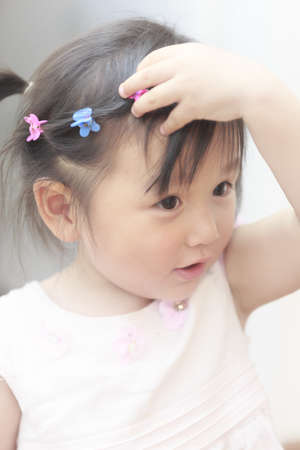 A close face of a happy little Chinese girlの写真素材