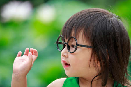 A Chinese girl wearing black framed glasses