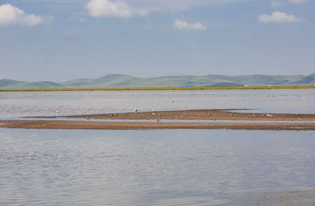 Landscape scenery view of a plateau under the blue sky with white cloudsの写真素材