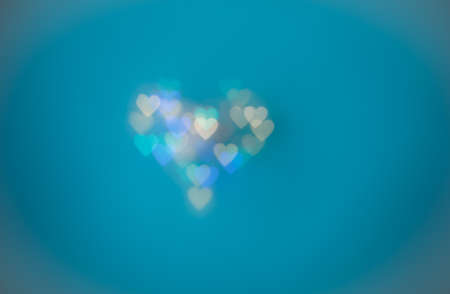 Numerous heart shaped spots on the blue  backgroundの写真素材