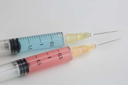 Two syringes on a white backgroundの写真素材
