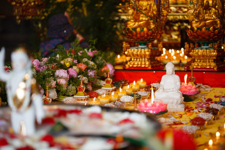 Buddha statue and candles for worship in a temple in Thailand