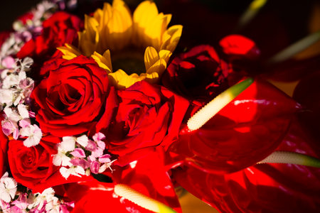 Beautiful bouquet of red roses and yellow anthurium flowersの写真素材