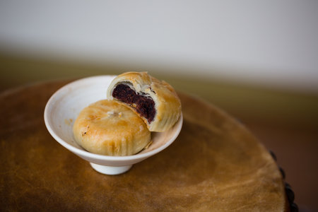 Puff pastry with poppy seeds on a white plate. Selective focus.