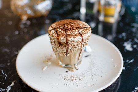 tiramisu in a glass on a table in a cafeの写真素材