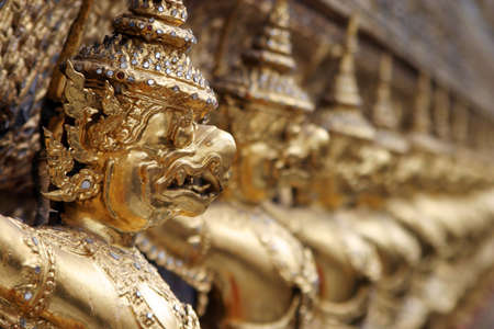A row of gargoyles outside the shrine of the Emerald Buddha in Wat Po, Bangkok, Thailand.の写真素材