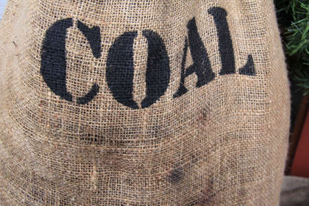 A horizontal image of a bag of coal for Christmas