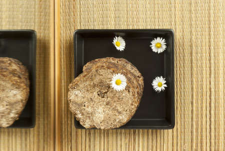 african handmade black soap on black square plate with flowers