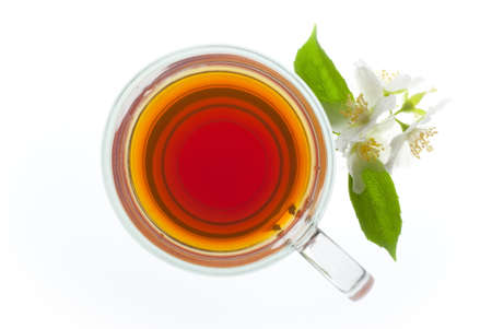 a cup of tea with jasmine flowers isolated on whiteの写真素材