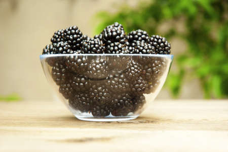 blackberries in bowl, on wooden table