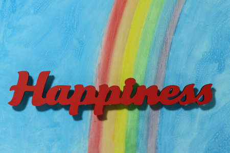 Red letters spelling the word happiness to illustrate the concept of joy, happy, love and wellness.の写真素材