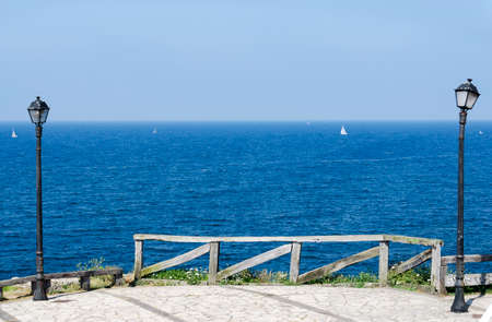 Beautiful view of the sea with a fence and two lampposts. Vacation conceptの写真素材