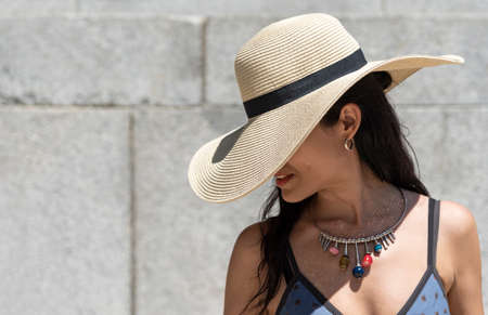 Portrait of a beautiful girl with a straw hat.の写真素材