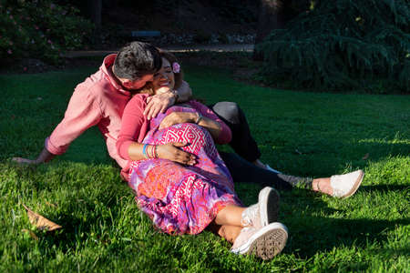 Beautiful young couple sitting in the park. Love conceptの写真素材