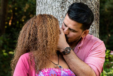Beautiful young couple kissing in the park. Love conceptの写真素材