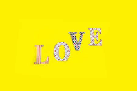 Vintage wooden love letters on yellow background with copy space. Romanticism concept.の写真素材