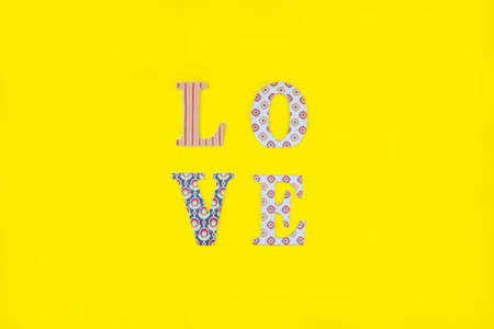 Vintage wooden love letters on yellow background with copy space. Romanticism concept.の写真素材