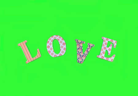 Vintage wooden love letters on green background with copy space. Romanticism concept.の写真素材