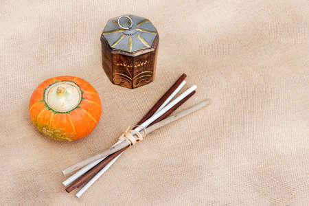 A healthy and organic pumpkin, a wooden box and some wooden sticks on rustic background with copy space.の写真素材
