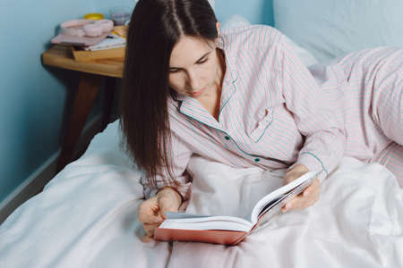 Cropped view of young calm brunette millennial smart cheerful mixed race woman student relaxing...