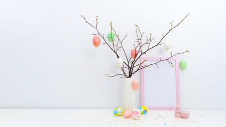 Trendy colorful Easter concept with hand painted eggs in yellow, grey colors, geometric vase,...