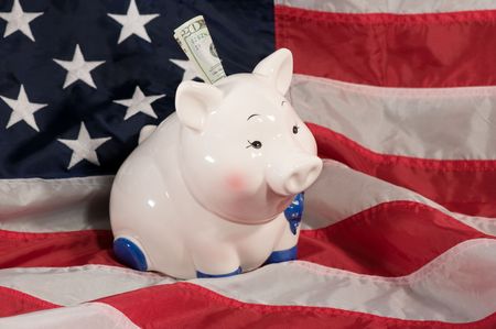 horizontal image of piggy bank on an american flagの写真素材