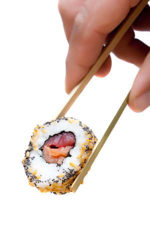 closeup holding sushi with chopsticks on a white backgroundの写真素材