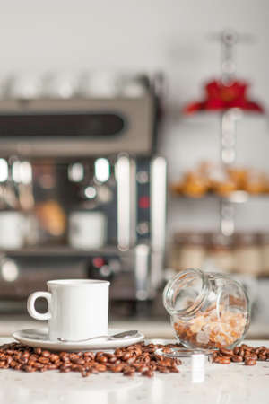 closeup of coffee cup and sugar cubes on a counter