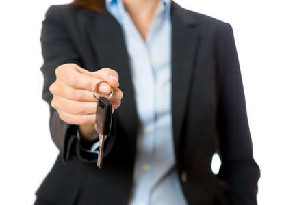 business woman offering a key car isolated on a white background