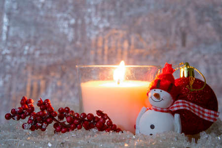 Christmas composition consisting of a lighted white candleの写真素材