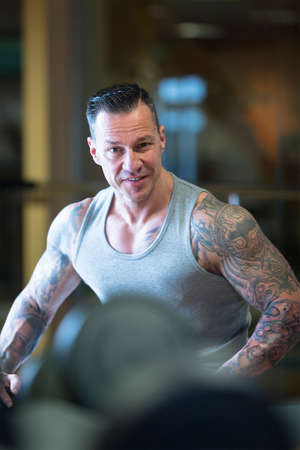 portrait of a male athlete looking at the camera at the gym  - focus on the man faceの写真素材