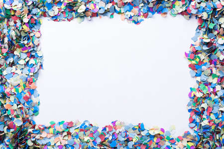 confetti background consisting of small pieces of colored paper with a blank place suitable as copy spaceの写真素材