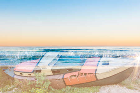 double exposure of an old boat and a desert beach on a backgroundの写真素材