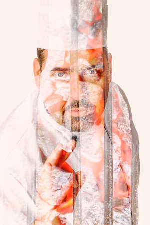 double exposure of a male chef showing a ok sign with coals on a grill on background