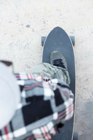subjective view of a foot of a skater on a skateboard - focus on the shoe