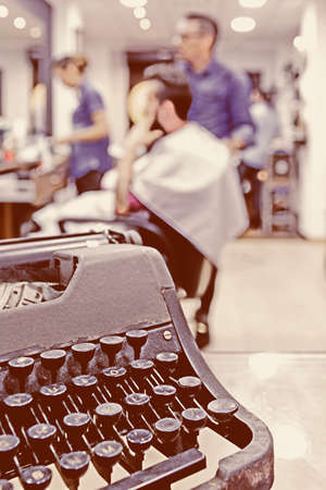 detail of a vintage typewriter on a barbershop - focus on the typewriterの写真素材