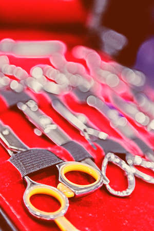 closeup of a collection of scissors useful as a background - focus on the first scissors