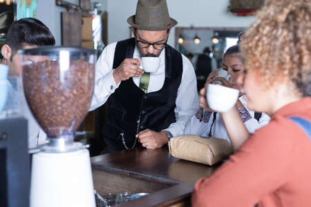 Four people degustate coffee in barの写真素材