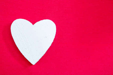White heart on red background. Isolated, close-upの写真素材