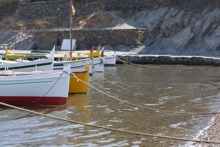 Several boats moored in bay with ropes in sunlight. Cpy space areaの写真素材