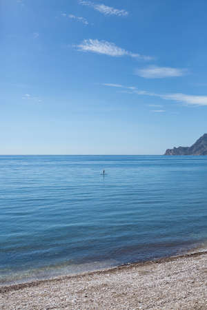 Unrecognizable person on surf near coastline.Copy space.の写真素材