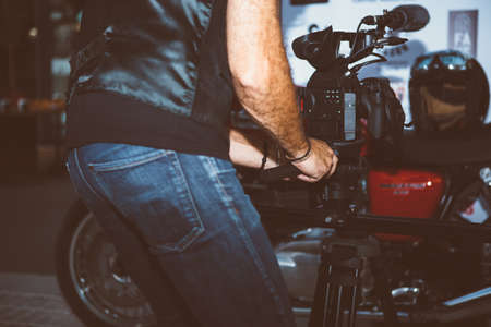 Back view of unrecognizable newstaper filming bike exhibitionの写真素材
