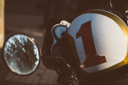 Close-up of helmet with number one on bike in sunlightの写真素材