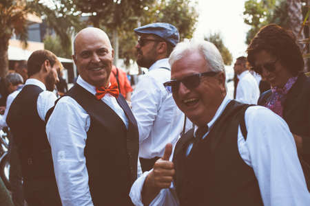 ALICANTE, SPAIN - SEPTEMBER 25, 2016: Smiling middle aged man is looking at camera while his friend is showing the thumb up on the Distinguished Gentleman's Ride day, a global fundraiser for prostate cancer and men's health investigationのeditorial素材