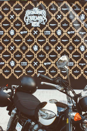 ALICANTE, SPAIN - SEPTEMBER 25, 2016: Triumph motorbike parked with a Distinguished Gentleman's ride board at the background on the Distinguished Gentleman's Ride day, a global fundraiser for prostate cancer and men's health investigation.のeditorial素材